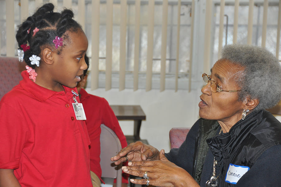 Rose Centers participant talking with young child