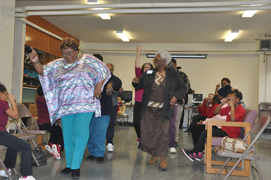 Rose Centers participants line dancing and laughing