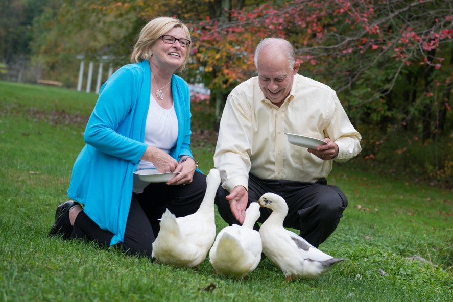 Two care partners and SHARE for Dementia participants feeding ducks