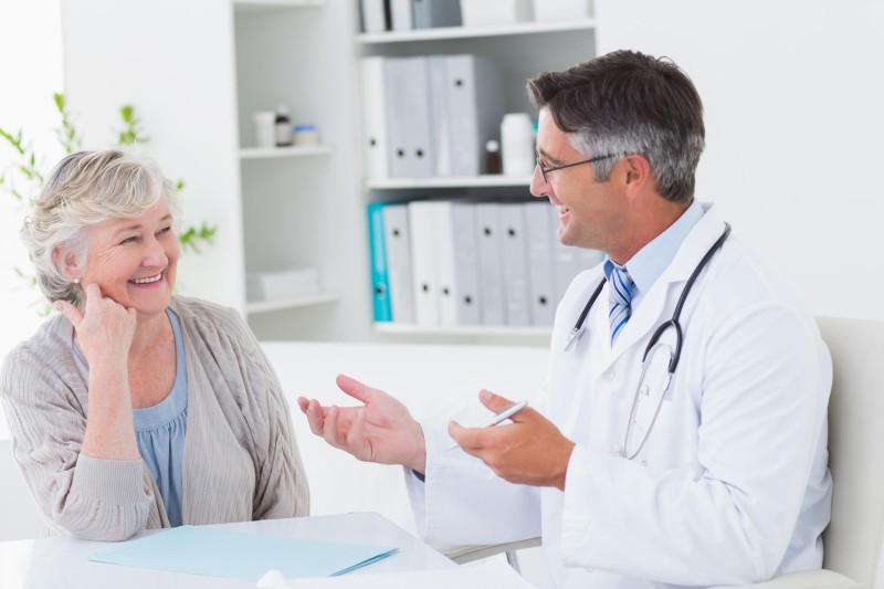 An older adult talking confidently with their doctor