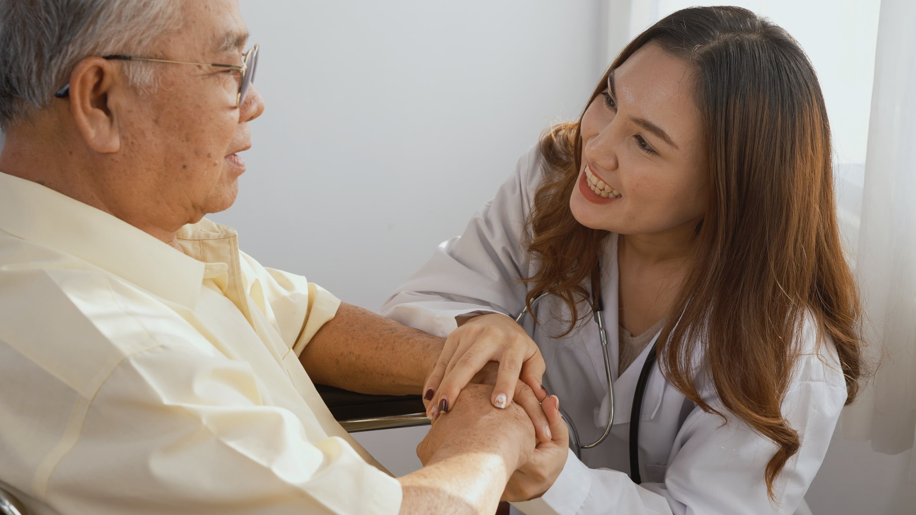 A professional caregiver talking with an older adult