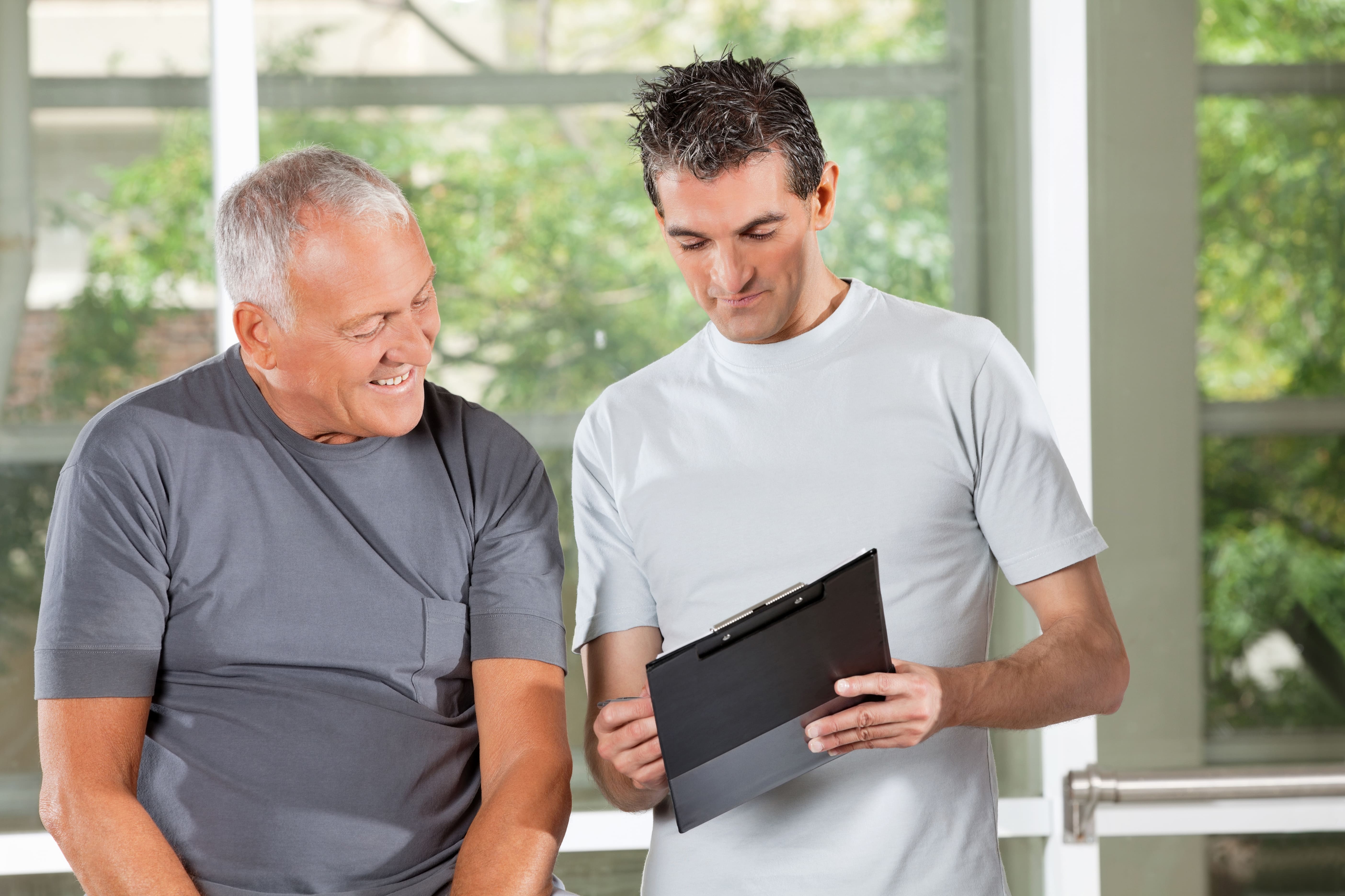 An older adult and caregiver looking over an emergency preparedness checklist
