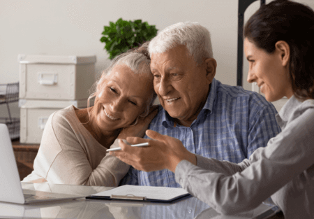 An older couple working with a benefits assessment professional 