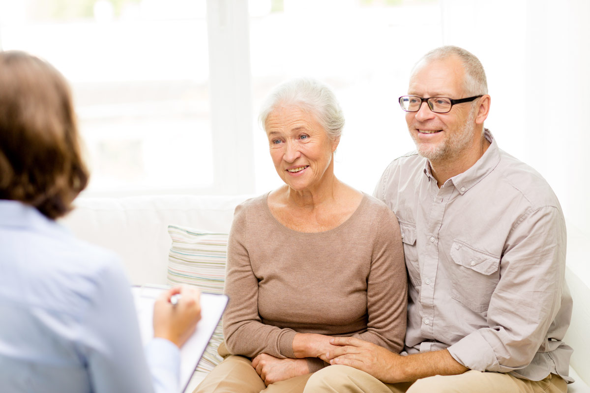 An older couple planning together with the help of a counselor