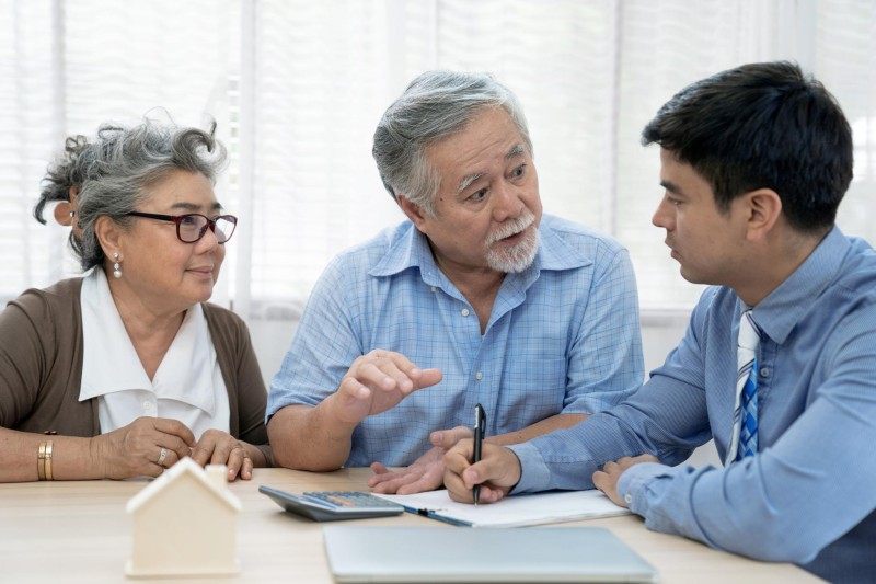 An older couple working on their financial goals with a counselor