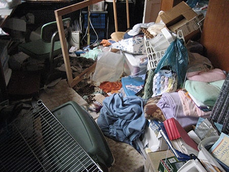 Household items and clothing on the floor of a room