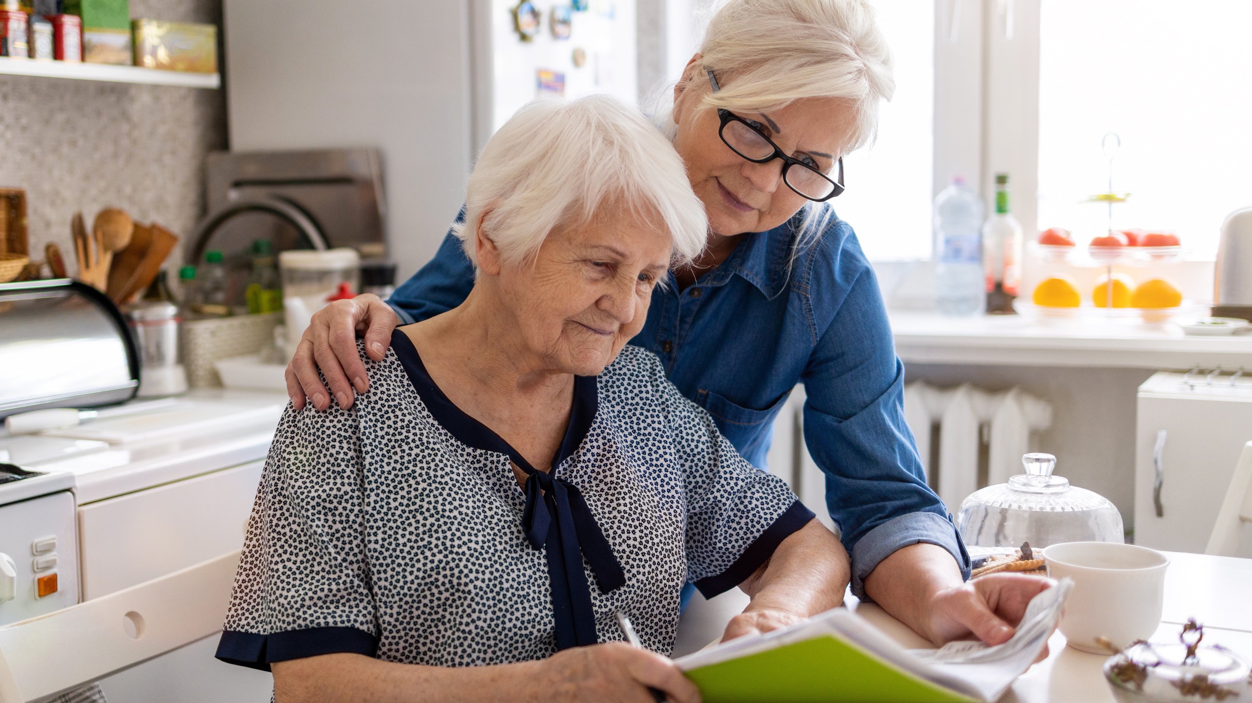 Two older adults reviewing financial documents together