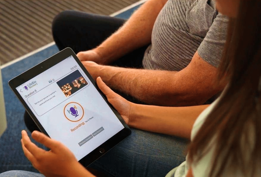 A caregiver and older loved one using the LifeBio app while recording a life story